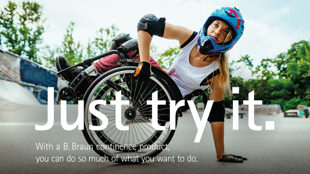 A wheelchair athlete wearing protective gear and a helmet performs a balancing trick on one hand at an outdoor skate park. The text on the image reads: "Just try it. With a B. Braun continence product, you can do so much of what you want to."