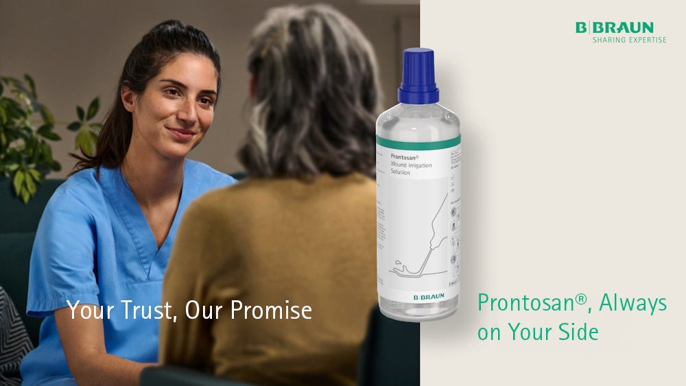A female nurse is sitting in front of a female patient, smiling.​ A Prontosan Wound Irrigation bottle is visible in the foreground, accompanied by the text: My patients appreciate it – and so do I. Prontosan.